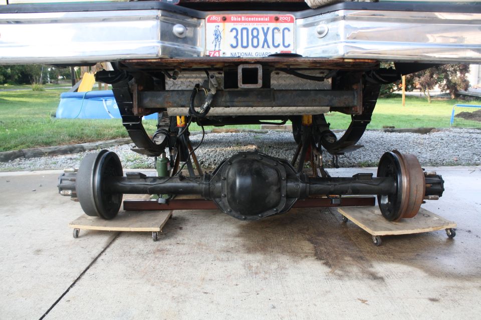 Rear axle assembly on dollies beneath a vehicle bumper with Ohio license plate 308XCC