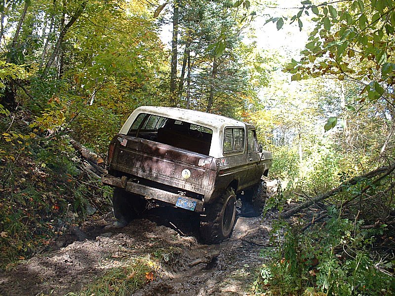 1978 Ford Bronco on a muddy trail, rear view