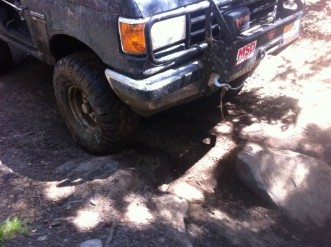 1990 Ford Bronco - This vehicle is equipped with a winch and brush guard, suggesting it is used for off-roading.