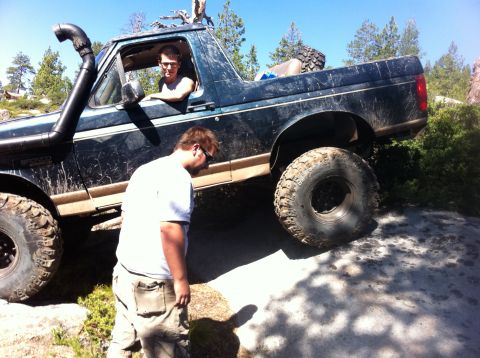 1990 Ford Bronco - Off-road adventure in a 1990 Ford Bronco navigating challenging rocky terrain.