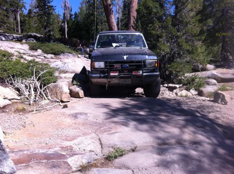 1990 Ford Bronco - This 1990 Ford Bronco navigates a challenging rocky path during an off-road excursion.