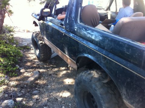 1990 Ford Bronco - This 1990 Ford Bronco is navigating a challenging rocky trail, showing its off-road capabilities.