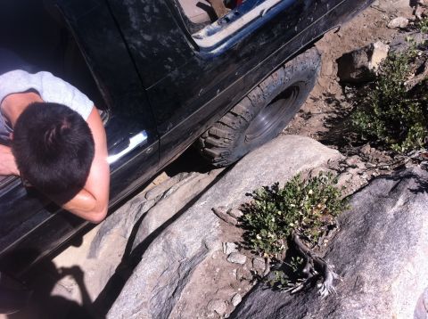 1990 Ford Bronco - Off-road vehicle navigating difficult rocky terrain.