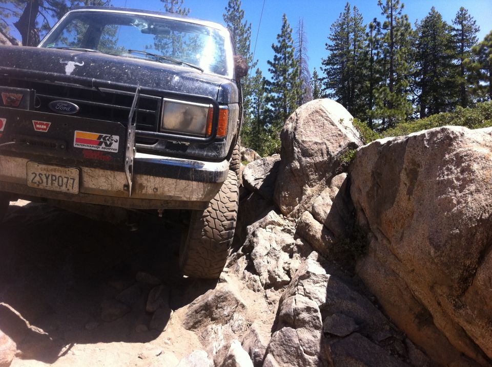 1990 Ford Bronco navigating rocky terrain