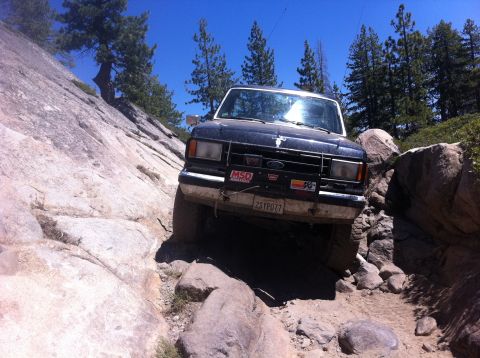 1990 Ford Bronco - This 1990 Ford Bronco is tackling a challenging rocky trail, demonstrating its off-road capabilities.