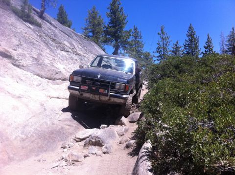 1990 Ford Bronco - This 1990 Ford Bronco is tackling a challenging off-road course on a sunny day.