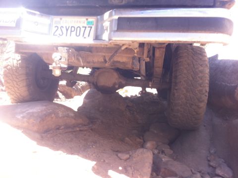 1990 Ford Bronco - This vehicle navigates rocky terrain, displaying a California license plate.