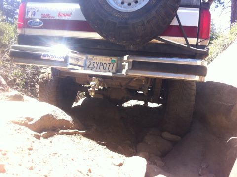 1990 Ford Bronco - Rear view of a 1990 Ford Bronco navigating rocky terrain.