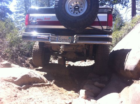 1990 Ford Bronco - This Ford Bronco is shown off-roading on a challenging rocky terrain.