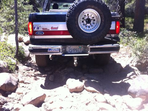 1990 Ford Bronco - Rear view of a 1990 Ford Bronco navigating a rocky trail.