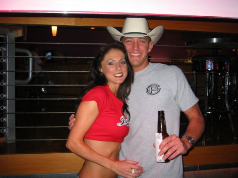 1989 Ford Bronco - A couple poses for a photo while holding a beer bottle at what appears to be a bar.