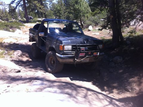 1990 Ford Bronco - This 1990 Ford Bronco navigates a rocky, wooded trail.