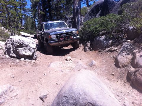1990 Ford Bronco - This 1990 Ford Bronco navigates a challenging rocky trail, its off-road capabilities.