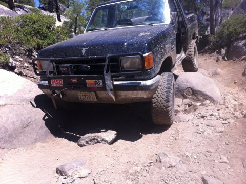 1990 Ford Bronco - This 1990 Ford Bronco navigates a challenging rocky trail, its off-road capabilities.