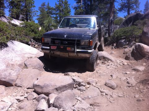 1990 Ford Bronco - This Ford Ranger navigates a challenging rocky terrain on a sunny day.