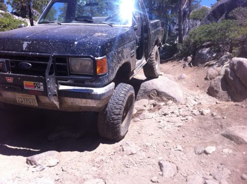 1990 Ford Bronco - This Ford Bronco is shown off-roading on a challenging rocky path.
