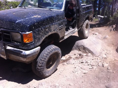 1990 Ford Bronco - This 1990 Ford Bronco tackles a challenging rocky path, with the driver's door ajar.