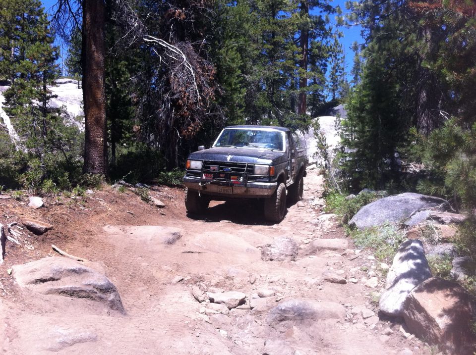 Black Ford Bronco on rocky trail, front view
