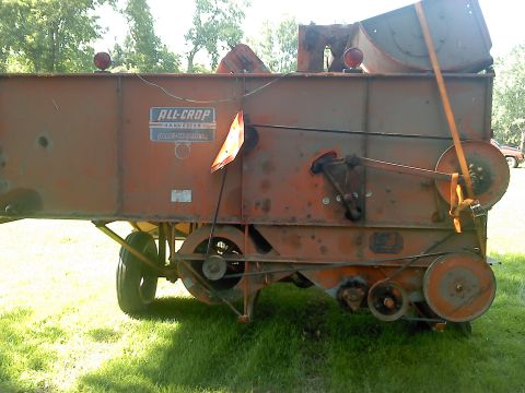 2000 Chevrolet Tahoe - An orange agricultural harvesting machine is shown from its side, with visible belts and pulleys.