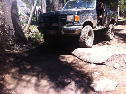 1990 Ford Bronco - This black Ford Bronco navigates a challenging rocky trail, its off-road capabilities.