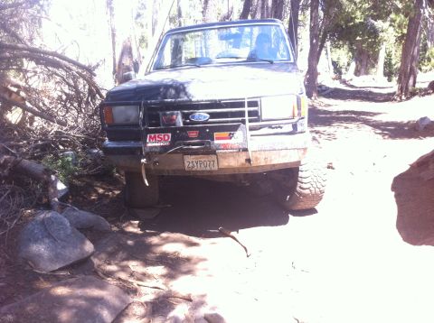 1990 Ford Bronco - This 1990 Ford Bronco navigates a rocky, wooded trail, its off-road capabilities.