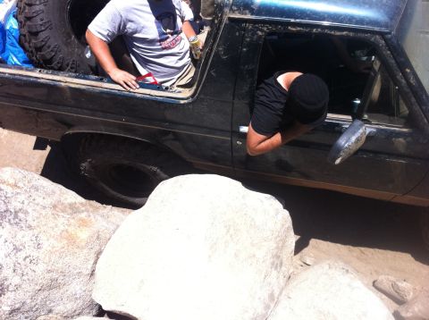 1990 Ford Bronco - This 1990 Ford Bronco is tackling a challenging off-road course with large boulders.