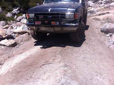 1990 Ford Bronco - This Ford truck, likely from the late 1980s, navigates a challenging rocky path.