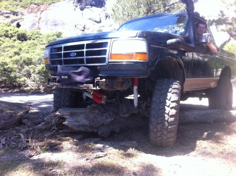 1990 Ford Bronco - This modified 1992 Ford Bronco navigates a rocky trail with a snorkel and lifted suspension.