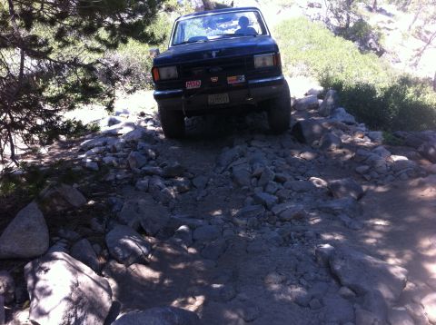 1990 Ford Bronco - This 1990 Ford Bronco tackles a challenging rocky path, demonstrating its off-road capability.