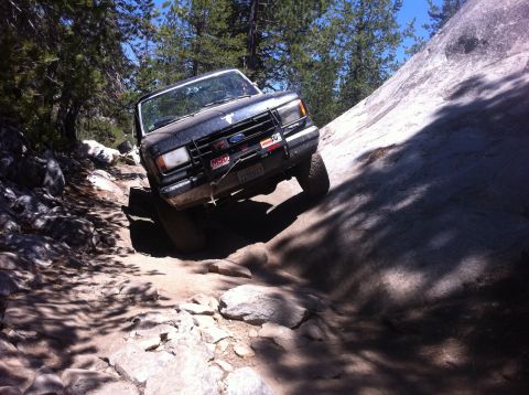 1990 Ford Bronco - This 1990 Ford Bronco is tackling a challenging rocky trail, demonstrating its off-road capabilities.