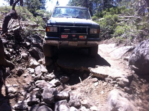 1990 Ford Bronco - This 1990 Ford Bronco is tackling a challenging rocky trail, demonstrating its off-road capability.