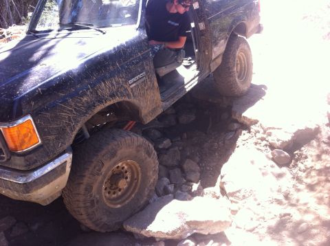 1990 Ford Bronco - This 1990 Ford Bronco tackles a challenging rocky path, demonstrating its off-road capabilities.