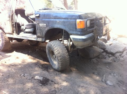 1990 Ford Bronco - This Ford Bronco is navigating a challenging rocky path.