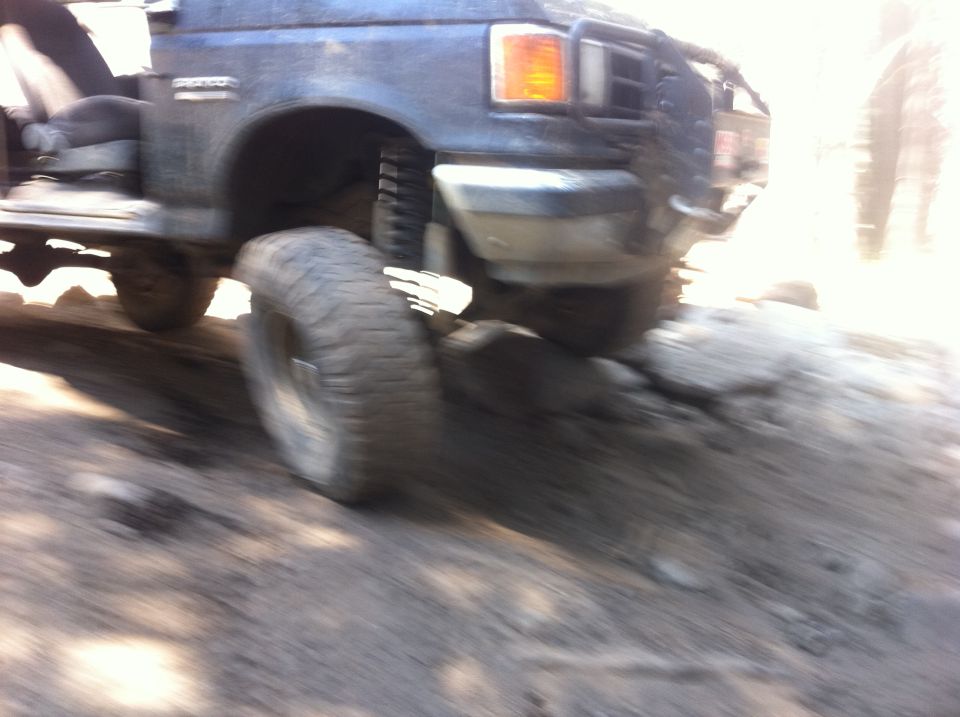 1990 Ford Bronco navigating rocky terrain