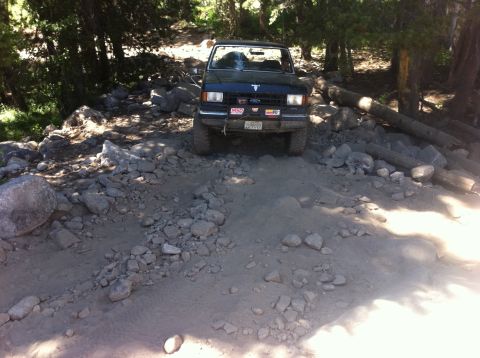 1990 Ford Bronco - This 1990 Ford Bronco is shown tackling a challenging, rocky off-road path.