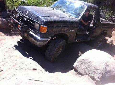 1990 Ford Bronco - This 1990 Ford Bronco is shown off-roading over large rocks.