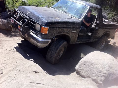 1990 Ford Bronco - Ford Bronco tackles a challenging rock obstacle during an off-road excursion.