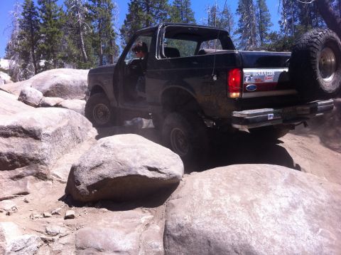 1990 Ford Bronco - This 1990 Ford Bronco is shown tackling a challenging off-road course with large boulders.