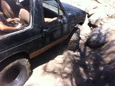 1990 Ford Bronco - This 1990 Ford Bronco is shown off-roading through a rocky, dusty trail.
