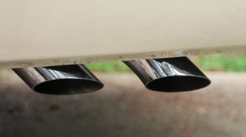 1976 Ford Ranchero - Close-up of dual chrome exhaust pipes on a vehicle.
