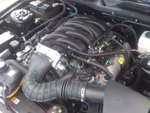 2008 Ford Mustang - Close-up view of the engine compartment of a Ford Mustang, highlighting the complex mechanical components.