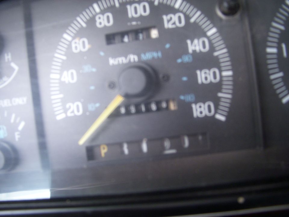 Dashboard gauges showing 65164 miles, P gear, and speedometer up to 180 mph