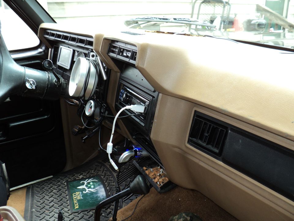 1986 Ford Bronco interior with aftermarket gauges and stereo