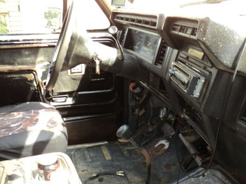 1986 Ford Bronco - Interior view of a truck, likely from the 1980s, with a focus on the dashboard and driver's side.