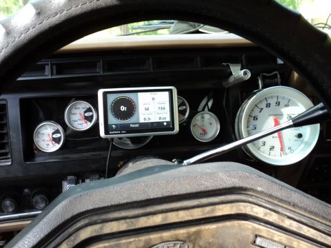 1986 Ford Bronco - The dashboard features several aftermarket gauges and a GPS unit, indicating a customized interior.