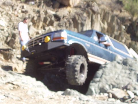 1993 Ford Bronco - A blue 1992 Ford Bronco navigates a rocky incline.