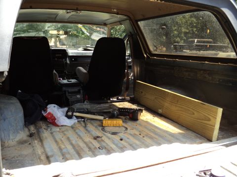 1986 Ford Bronco - The cargo area of this SUV contains tools and lumber, suggesting it's being used for a project.