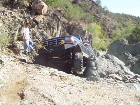 1993 Ford Bronco - This 1992 Ford Bronco tackles a challenging rocky incline, its off-road capabilities.
