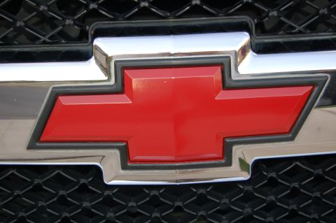 2007 Chevrolet Silverado 1500 - Close-up of the red Chevrolet bowtie emblem on the front grille of a 2007 Silverado 1500.