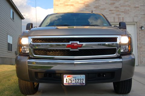 2007 Chevrolet Silverado 1500 - This Chevrolet truck has a prominent red bowtie emblem on its chrome grille and a Texas license plate.